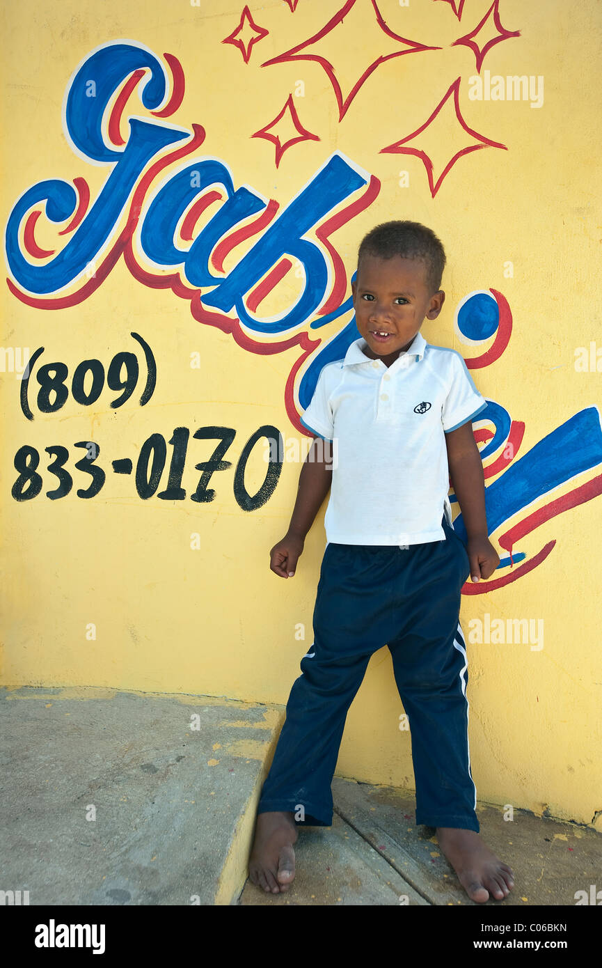 Young local boy outside shop, Bayahibe, Dominican Republic Stock Photo
