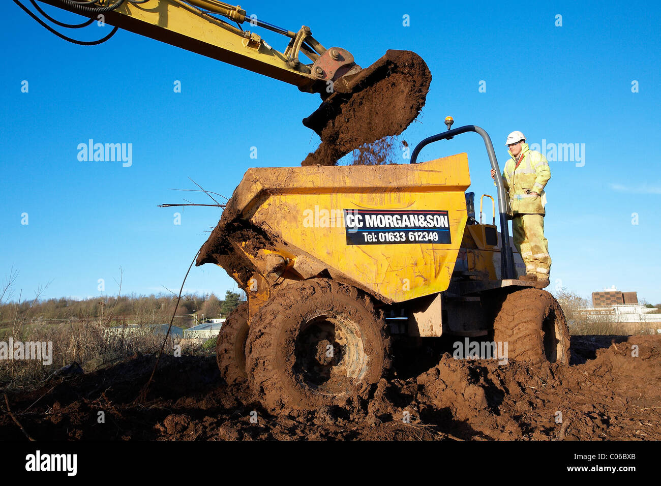 Dump truck getting filled full of earth Stock Photo