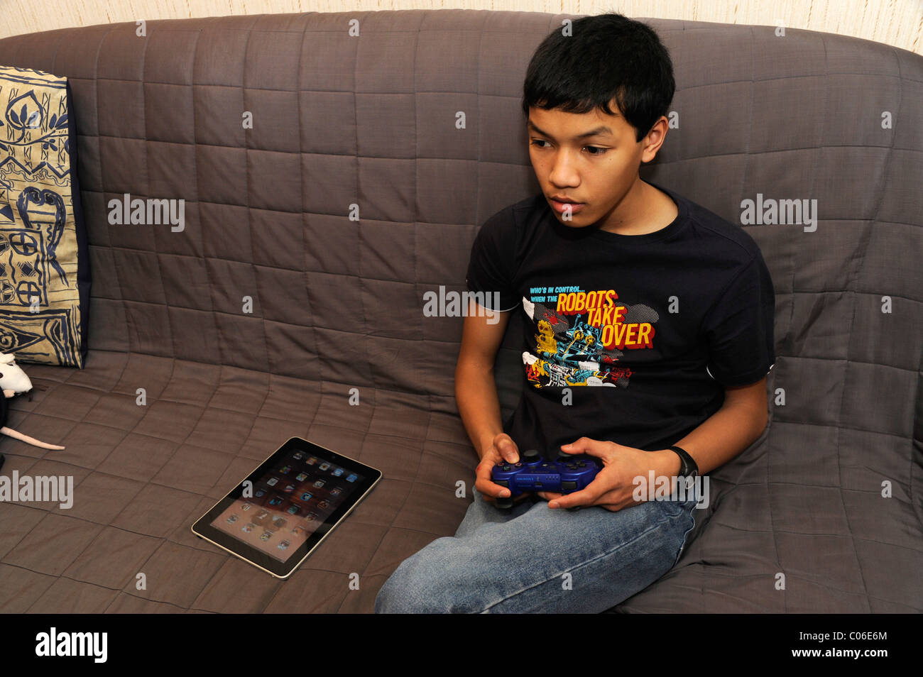 boy play PS3, Apple iPad,tablet computer Stock Photo - Alamy