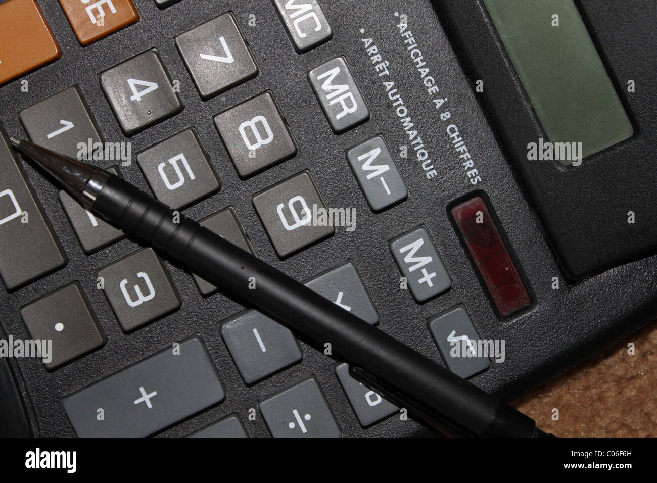 Calculator and pen Stock Photo