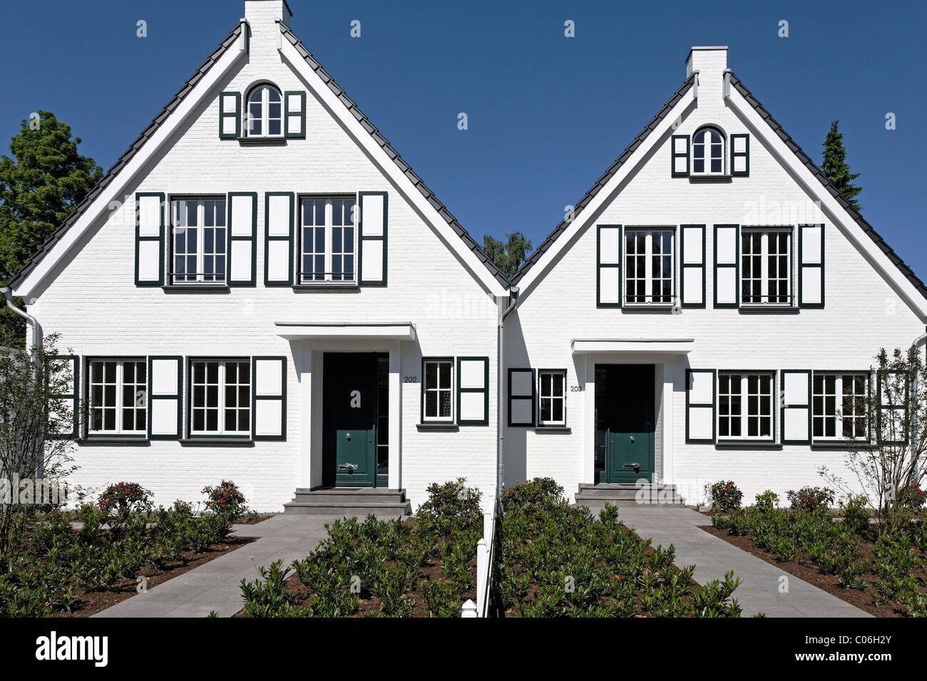 Two identical houses side by side, ready for moving in, Duesseldorf, North Rhine-Westphalia, Germany, Europe Stock Photo