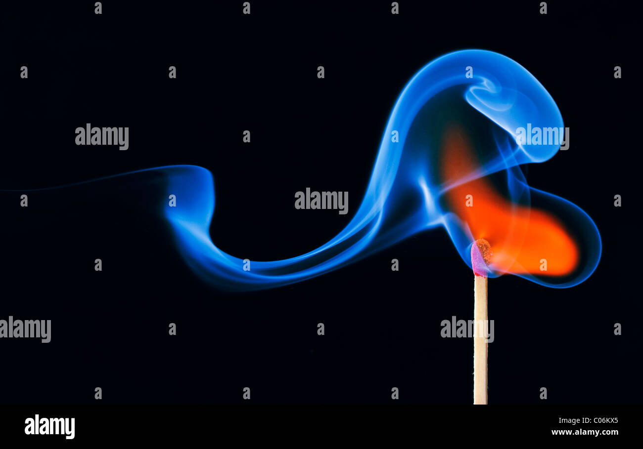 Lit match, flame and blue smoke Stock Photo