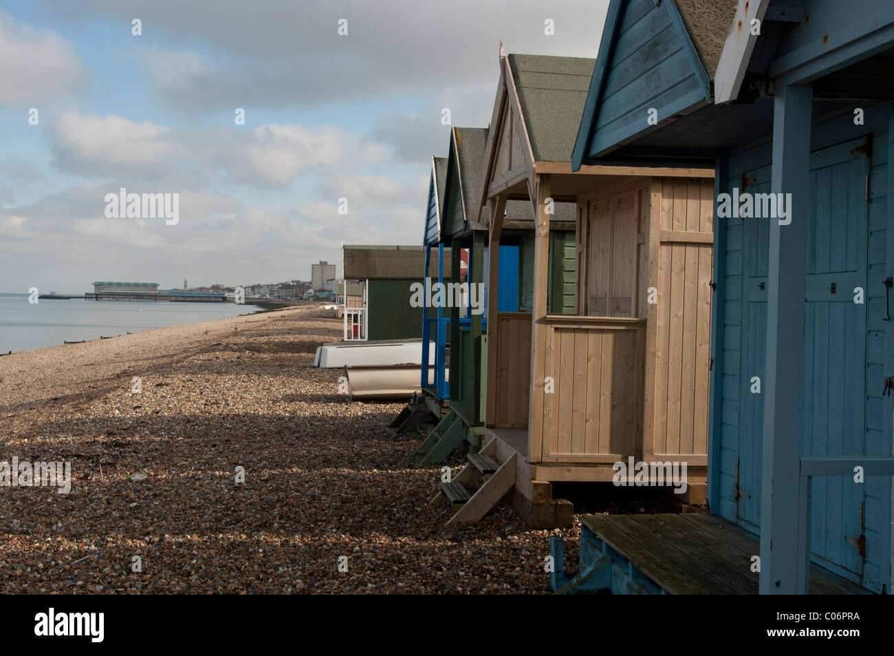 Beach huts on stoney beach Herne Bay seaside town in north kent england