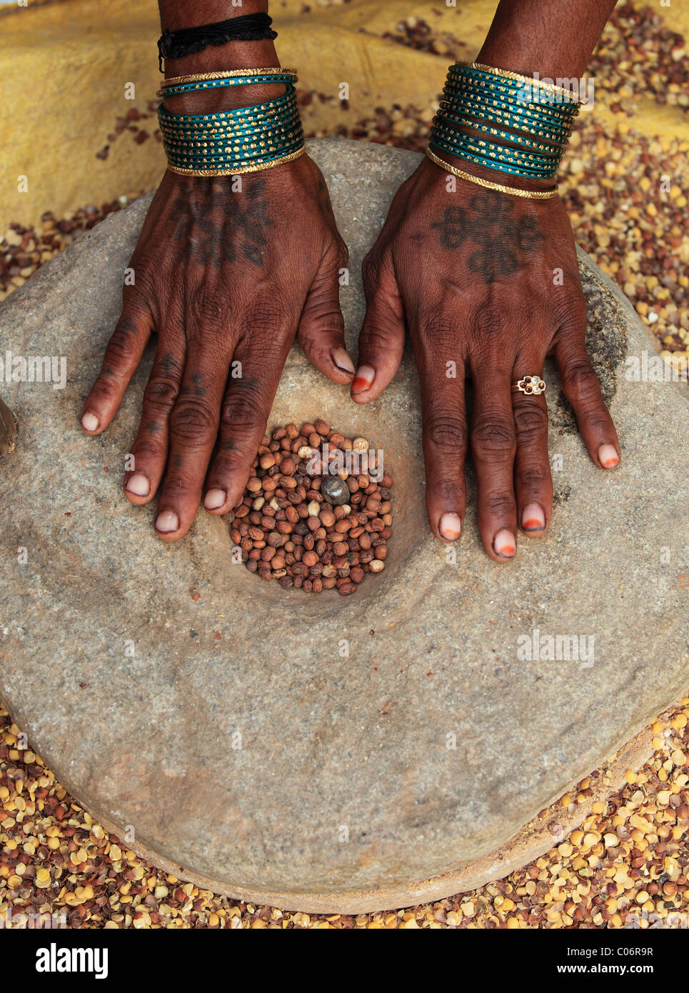 woman crushing grains  Andhra Pradesh South India Stock Photo