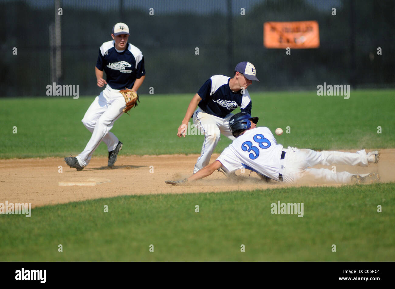 high school baseball game Runner slides in safely to second base Stock