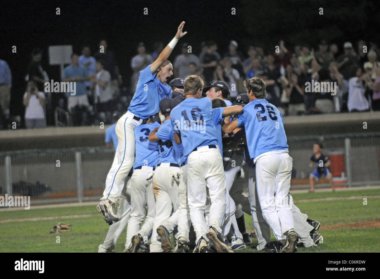 Team celebrates winning a state high school baseball championship immediately after the final out of the game. USA. Stock Photo