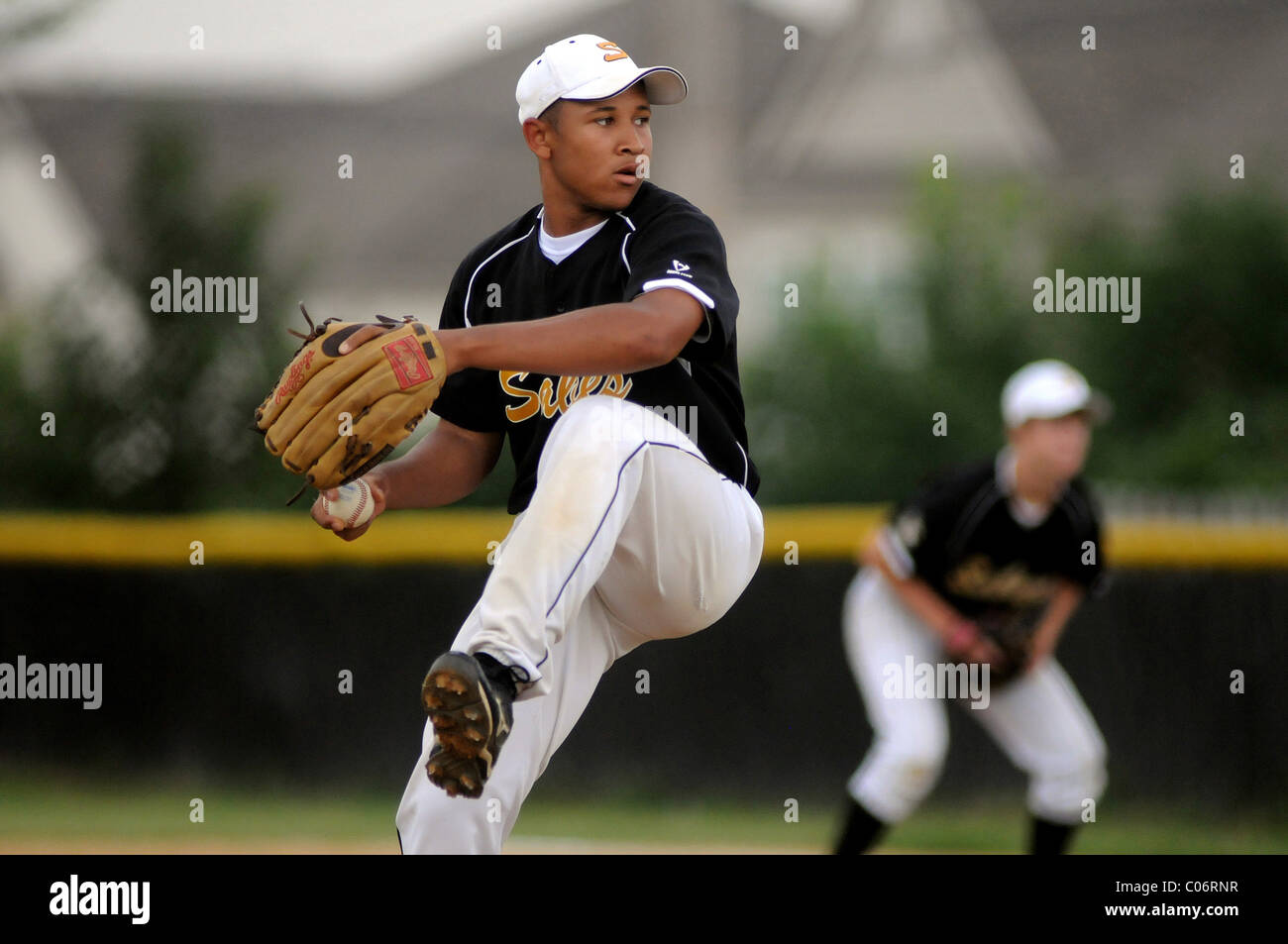 Pitcher studies his catcher's target as he kicks a begins his delivery