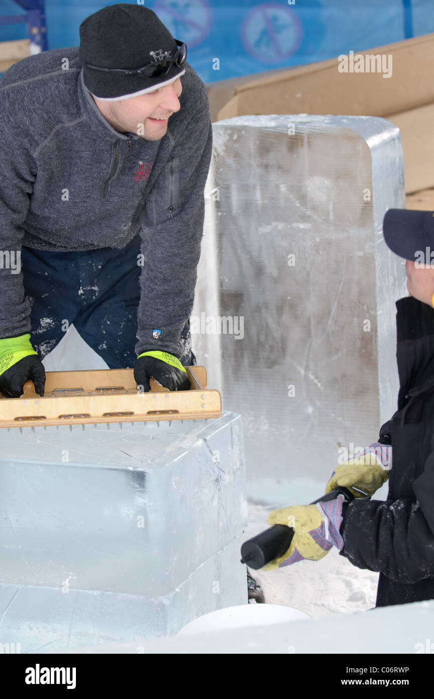 Teams of professional ice carvers work together to build massive ice sculptures based on the theme 'Yin and Yang' at Winterlude. Stock Photo