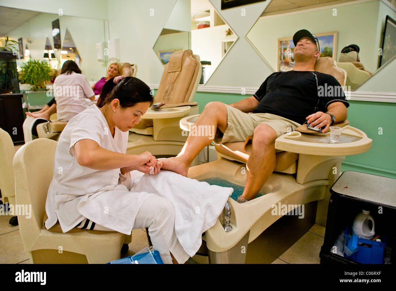 A happy man enjoys a pedicure performed by a Vietnamese technician in  Southern California Stock Photo - Alamy