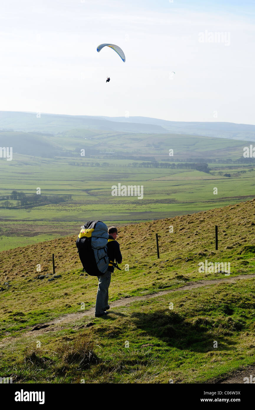 paraglider walking to the launch site rushup edge Derbyshire peak