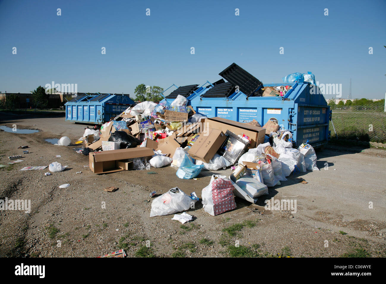 Recycle center drop off container overflows with bags and boxes of