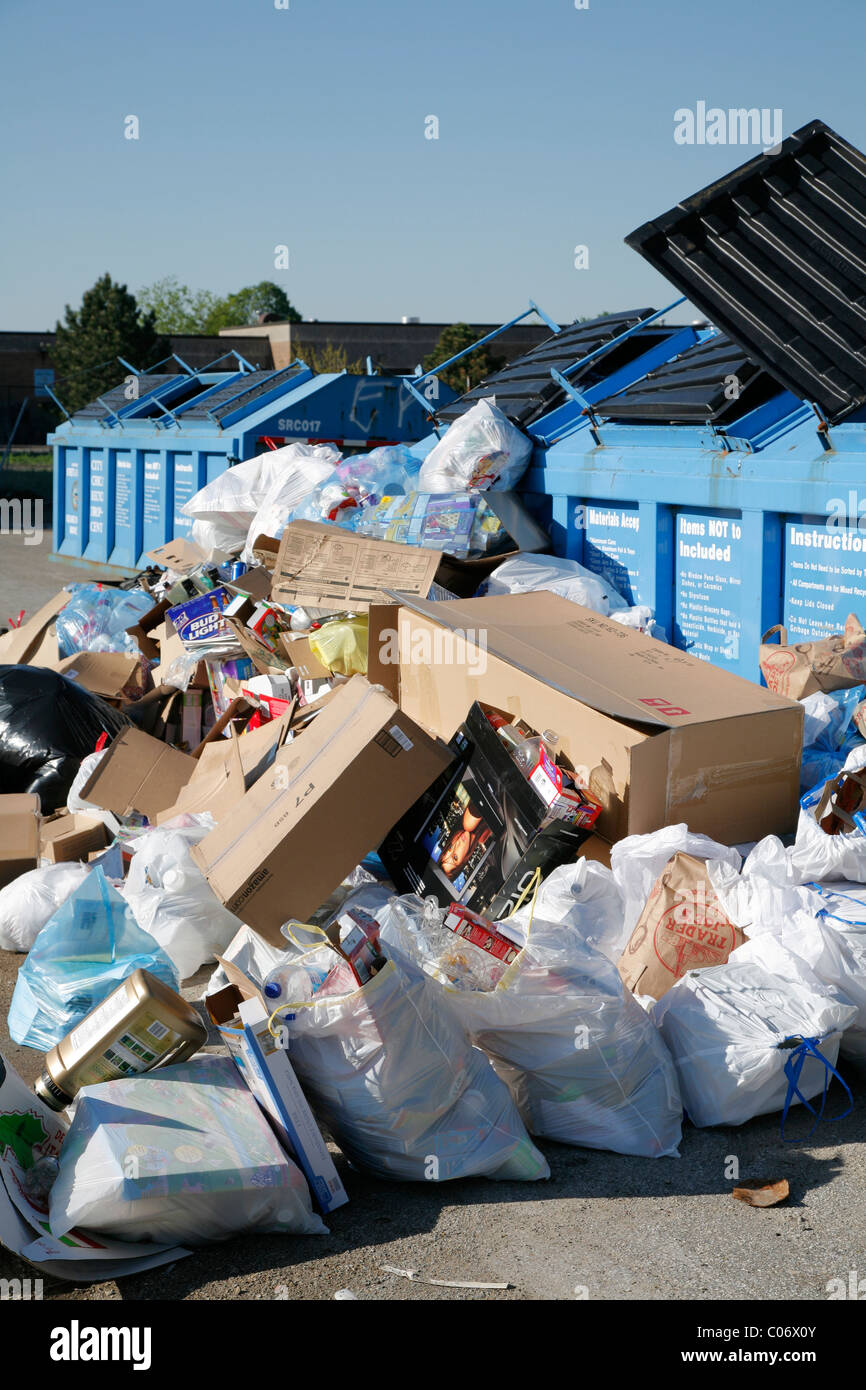 Recycle center drop off container overflows with bags and boxes of