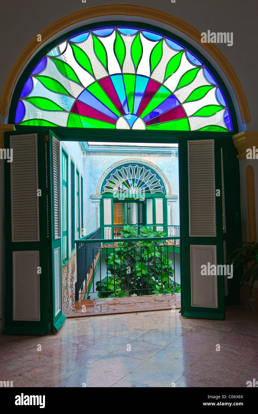 Cuba, Havana. An Arched Mediopunto (Stained Glass) Window in the Casa de los Arabes, an 18th century building. Stock Photo