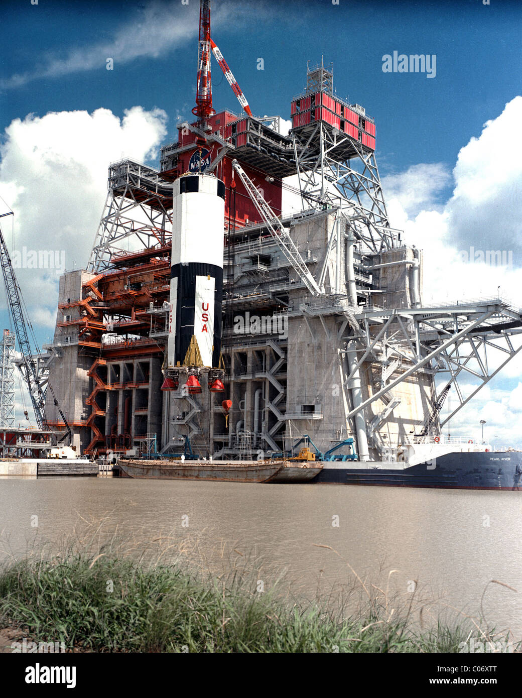 First Stage Of The Apollo Saturn V Moon Rocket Is Lifted By Crane For Stock Photo Alamy