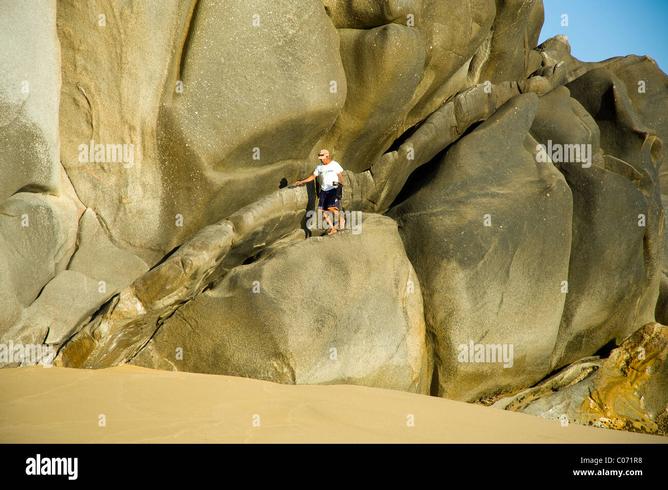 Guy Running Down Red Rocks Backwards young Mexican man running down rock formation near San Lucas Mexico ...