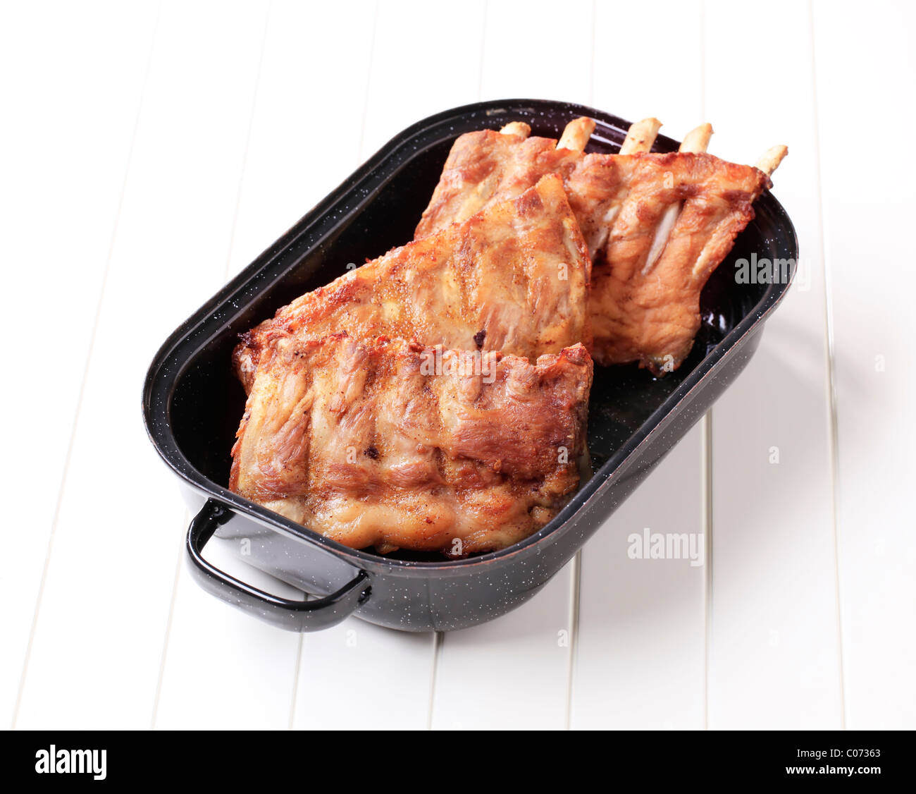 Oven-roasted rack of pork ribs in a pan Stock Photo