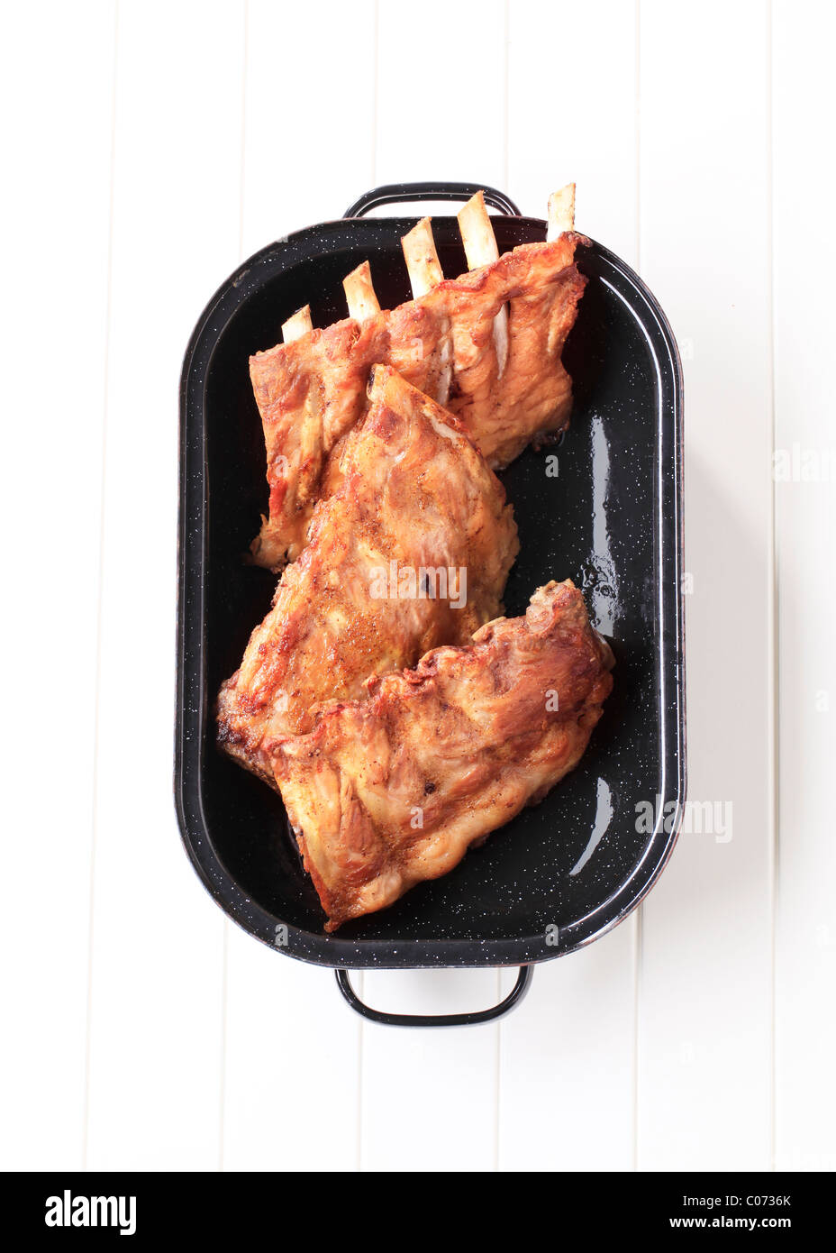 Oven-roasted rack of pork ribs in a pan Stock Photo