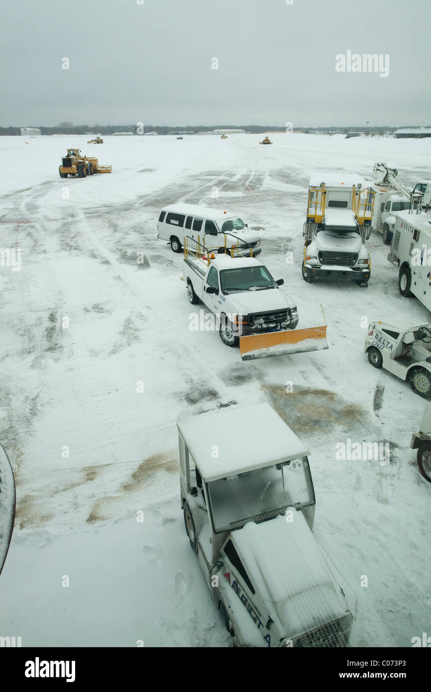 At Bradley International Airport, de-icing and snow removal equipment at an airline gate waits for a major storm to abate. Stock Photo