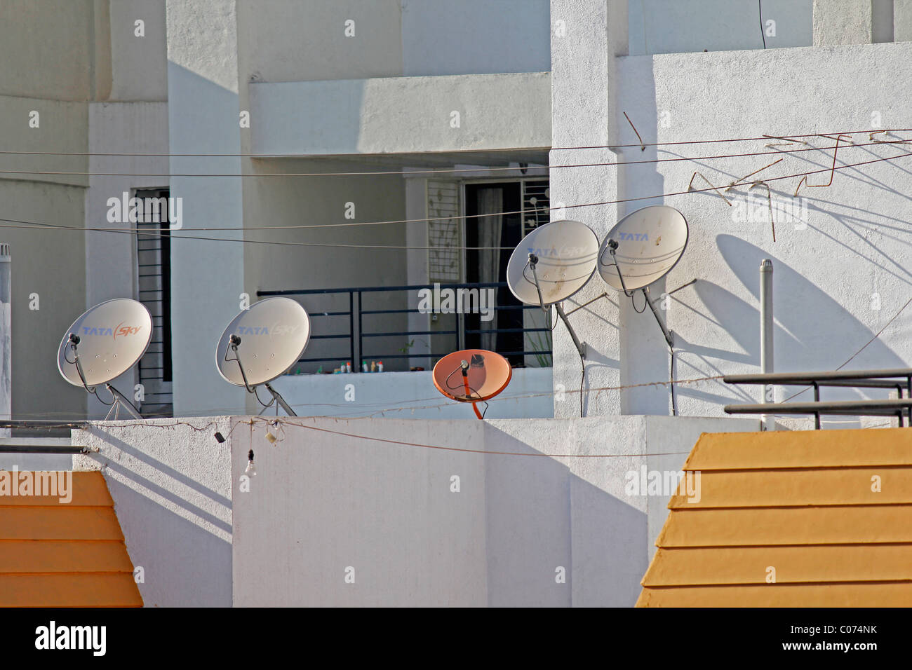 Dish antennas of a television set on a building terrace, Pune