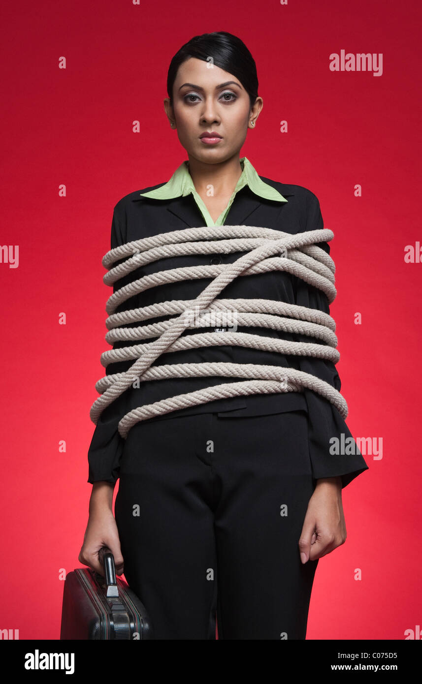 Portrait of a businesswoman tied up with rope Stock Photo