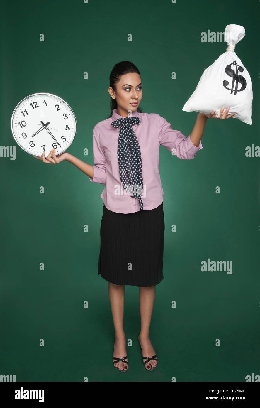 Businesswoman weighing time versus money Stock Photo - Alamy