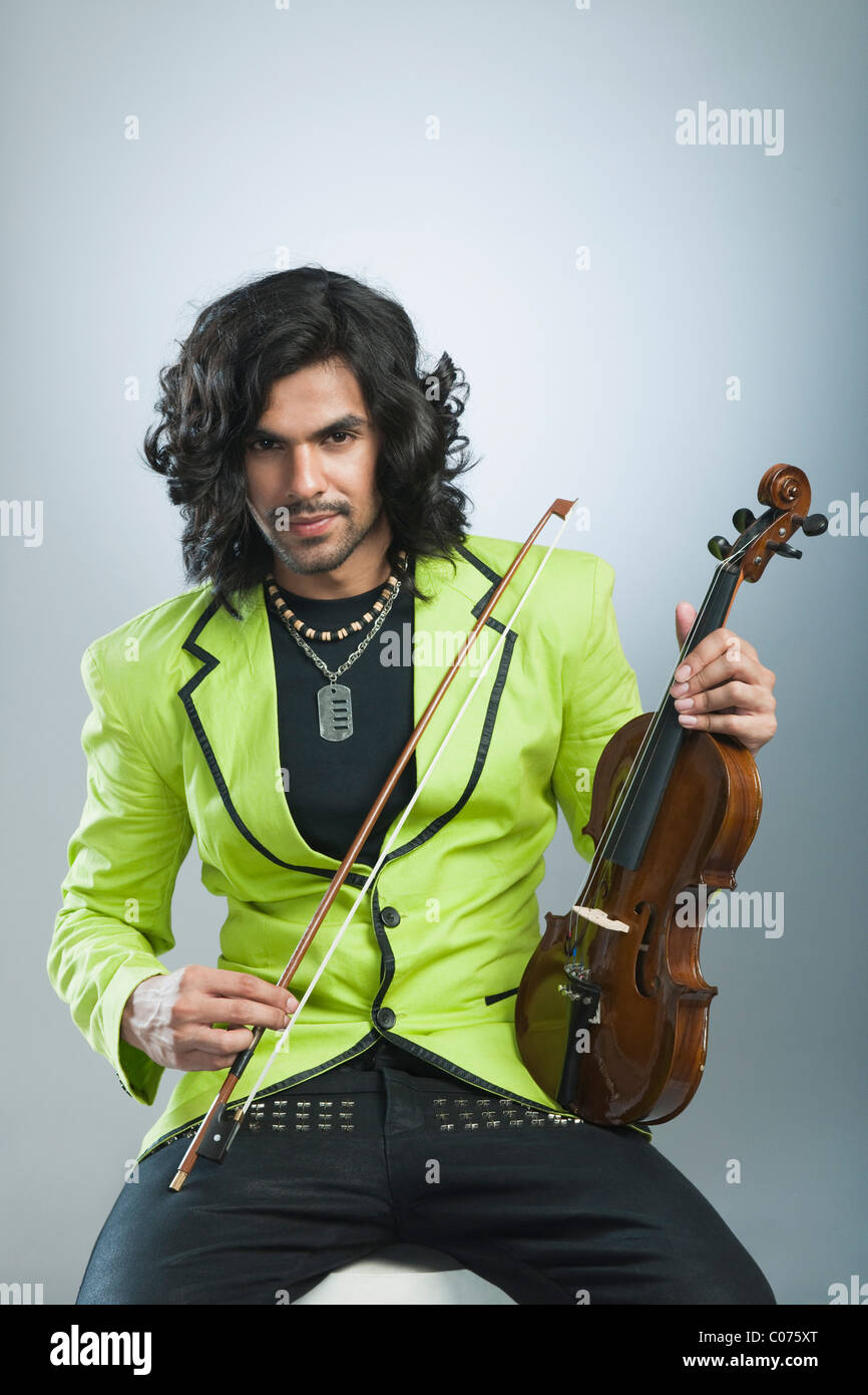 Portrait of a man holding a violin Stock Photo