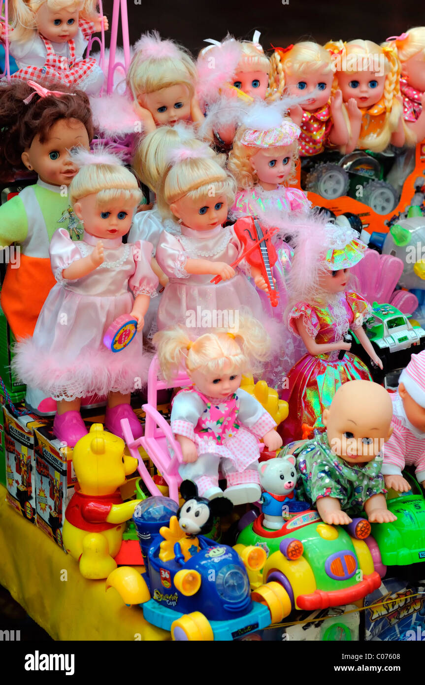 dolls toys girls childs childrens playthings on sale stand stall open air market Stock Photo
