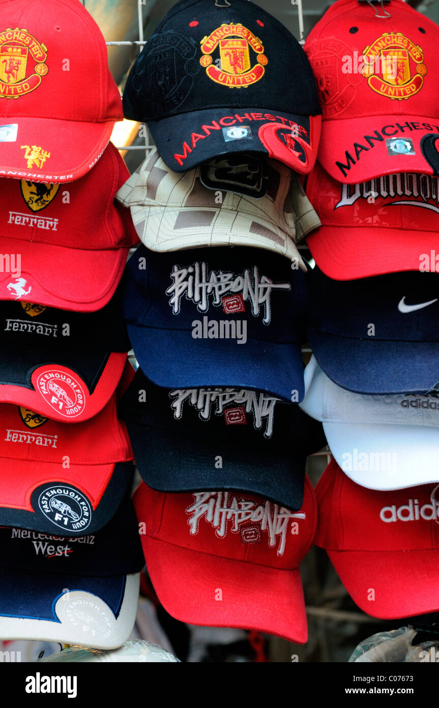fake designer pirate pirated luxury goods on sale stall petaling street chinatown kuala lumpur malaysia man utd baseball hats Stock Photo