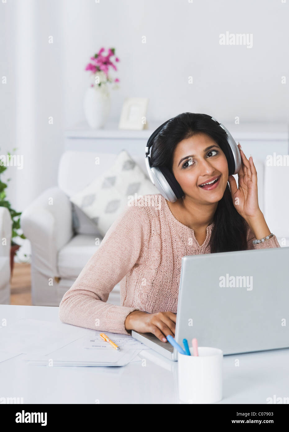Woman in headphones looking laptop hi-res stock photography and images ...