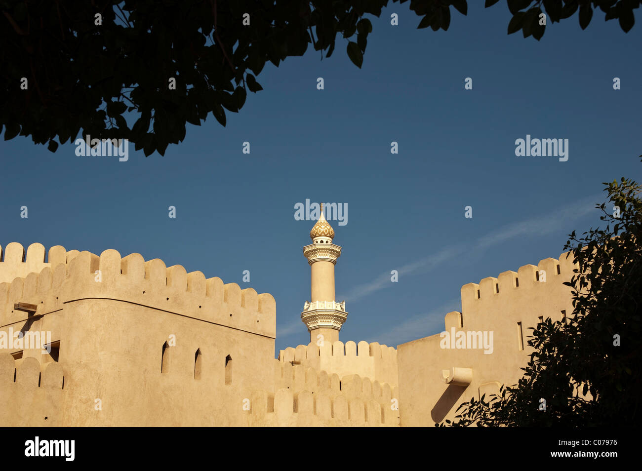 View of the fort of Nizwa, with the minaret of the Sultan Quaboos Mosque, Oman, Middle East Stock Photo