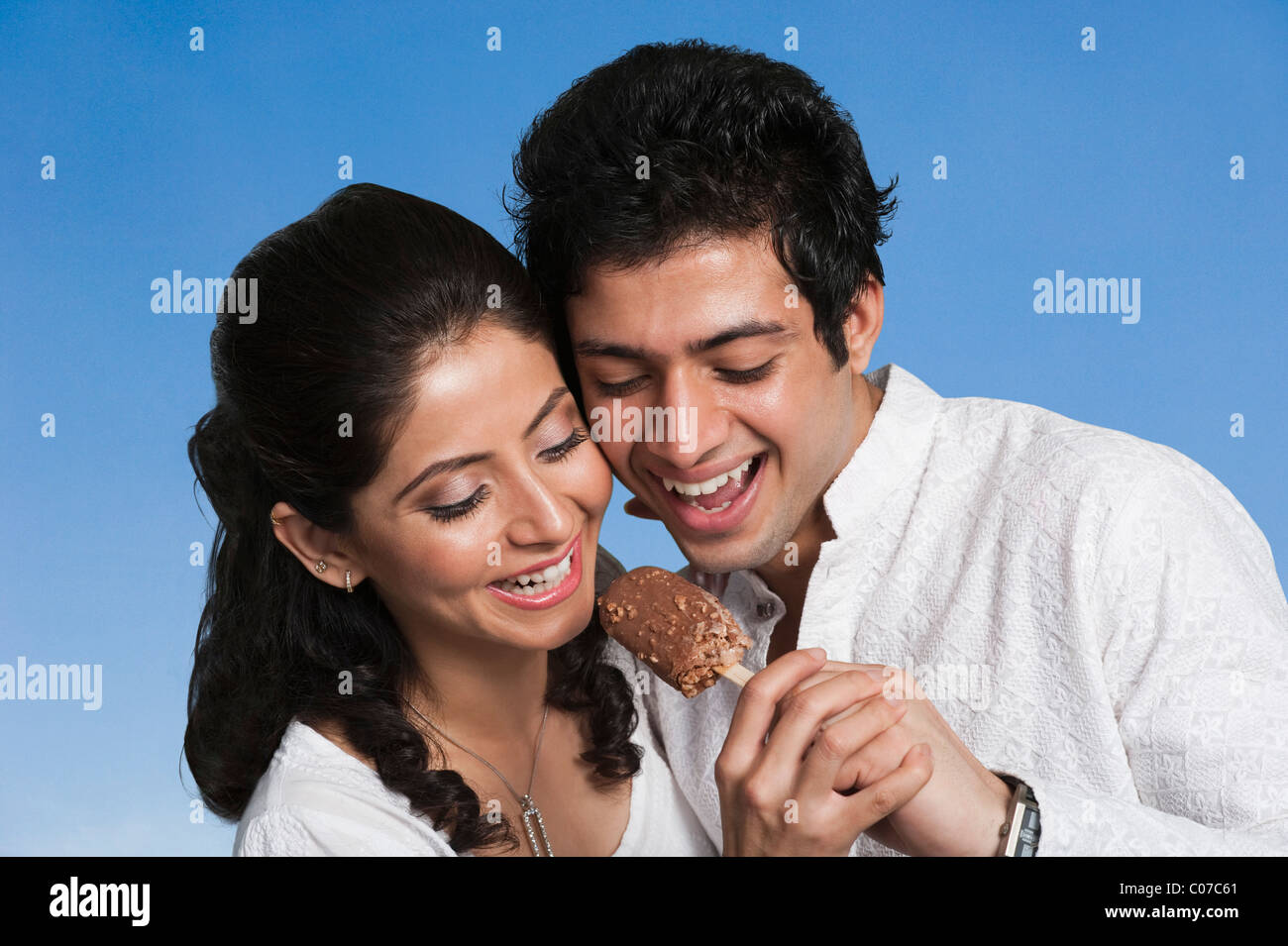 Man feeding an ice cream to a woman Stock Photo