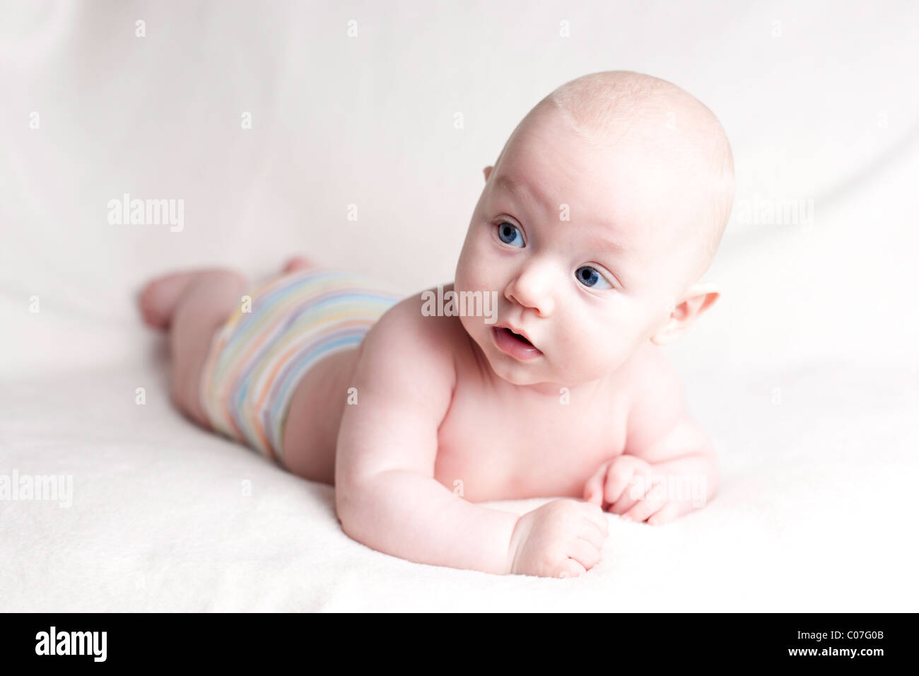 A high key photo of a 5 month old baby boy wearing stripy briefs Stock Photo