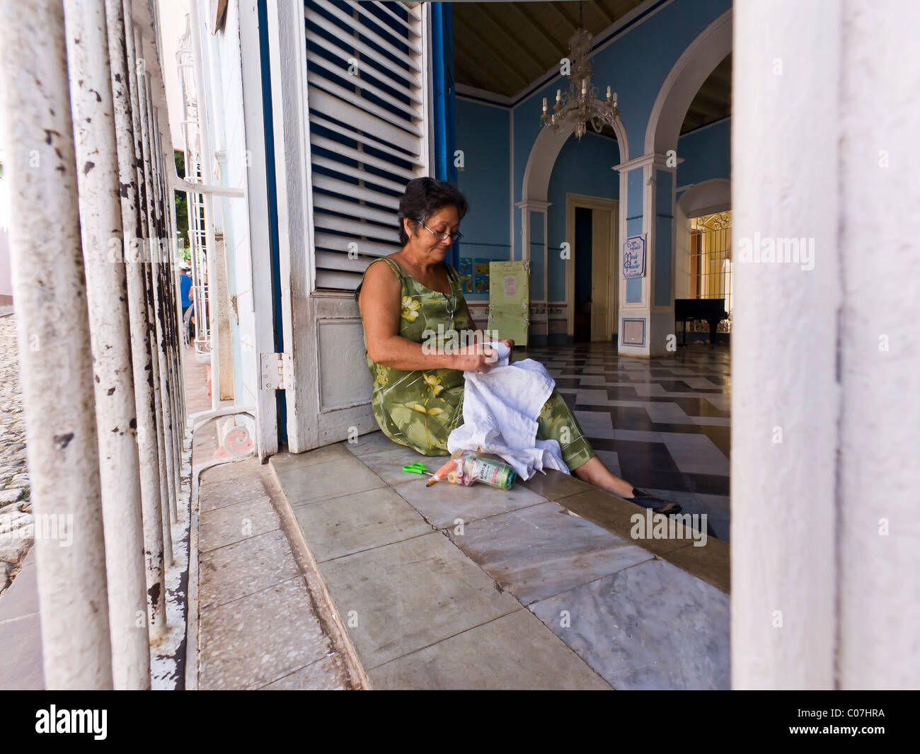 Woman crocheting in window Trinidad is a town in the province of Sancti Spíritus, central Cuba Stock Photo