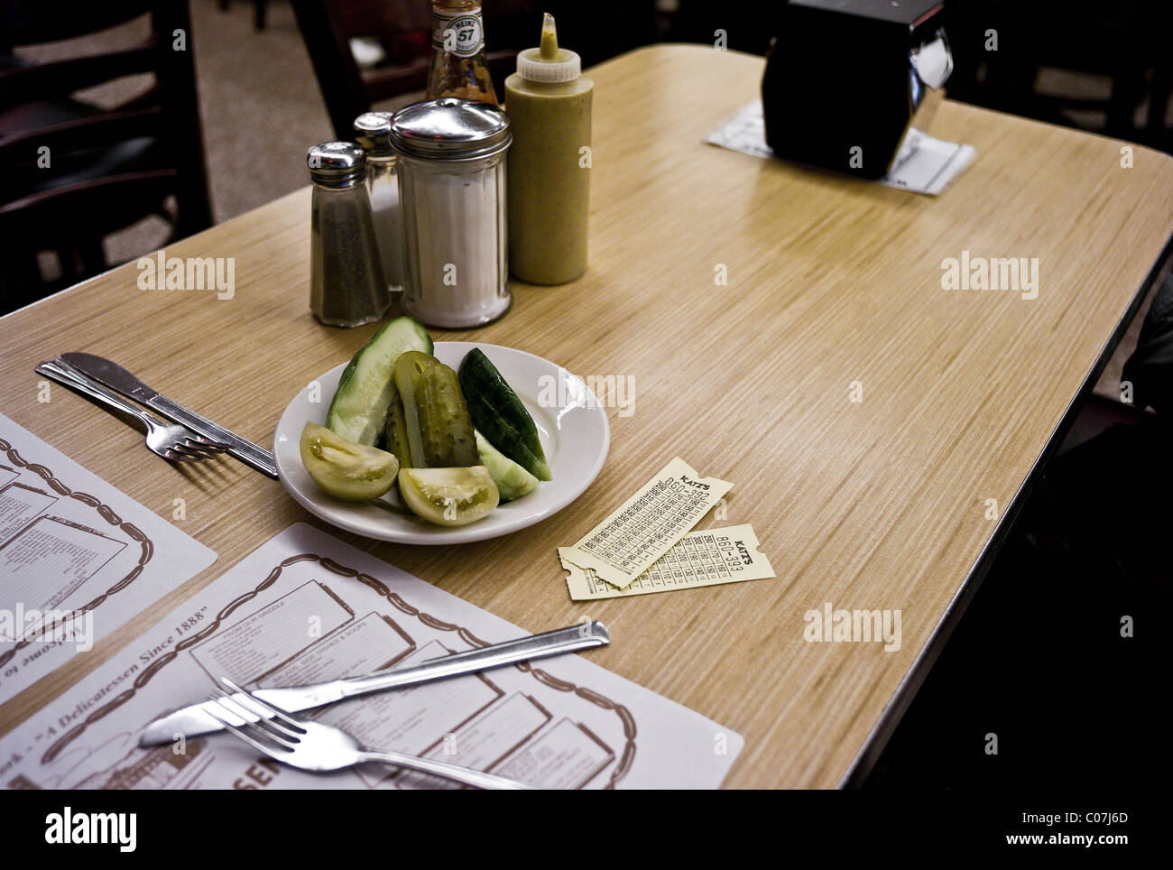 Pickles and a green tomato on a table in Katz Deli on E. Houston, New