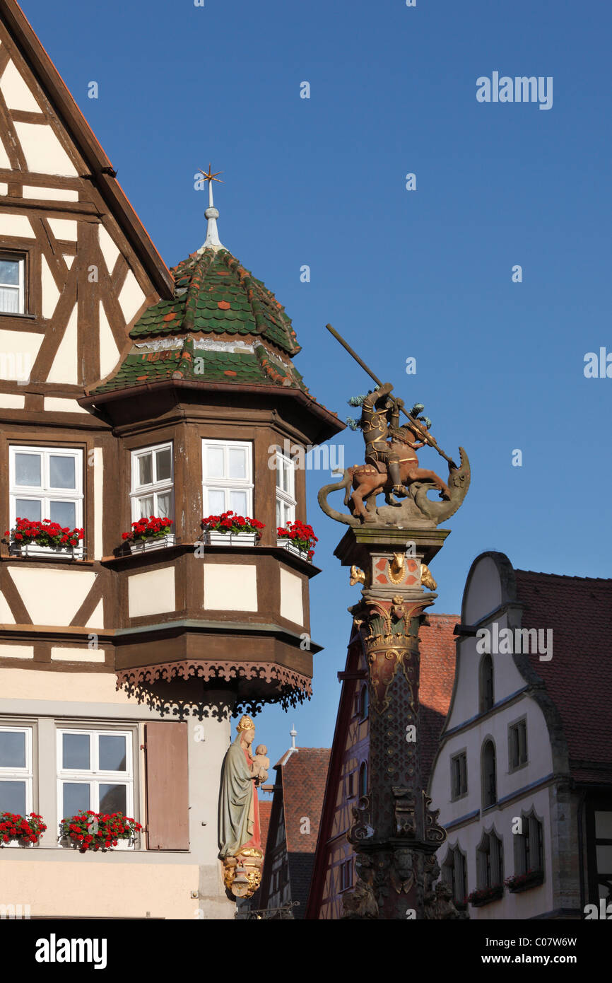 Bay window on the Marienapotheke pharmacy and equestrian monument of St. George, Rothenburg ob der Tauber, Romantic Road Stock Photo