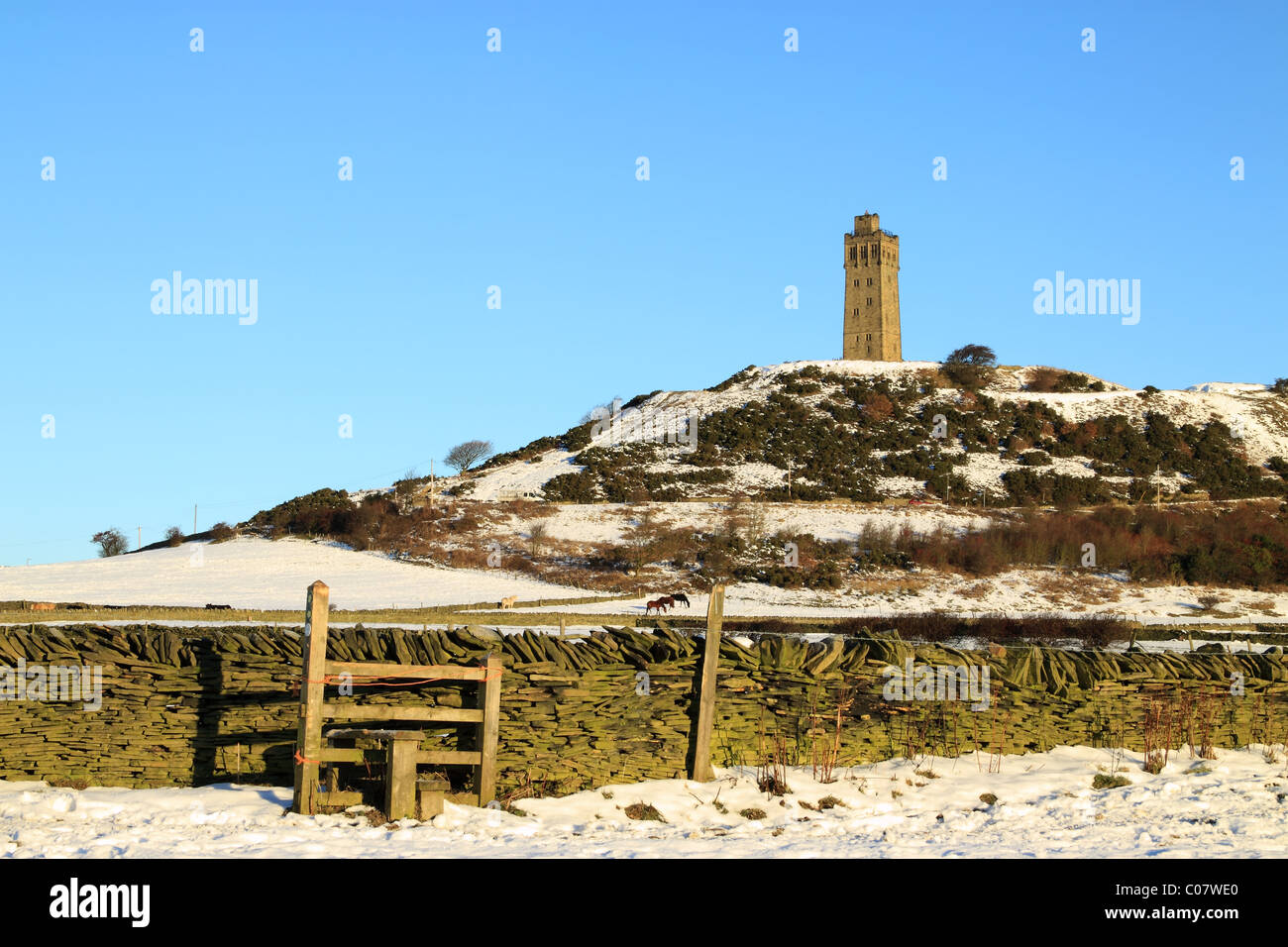 A snow covered wintertime view of the Jubilee Tower on Castle Hill, the well known landmark in Huddersfield, West Yorkshire Stock Photo
