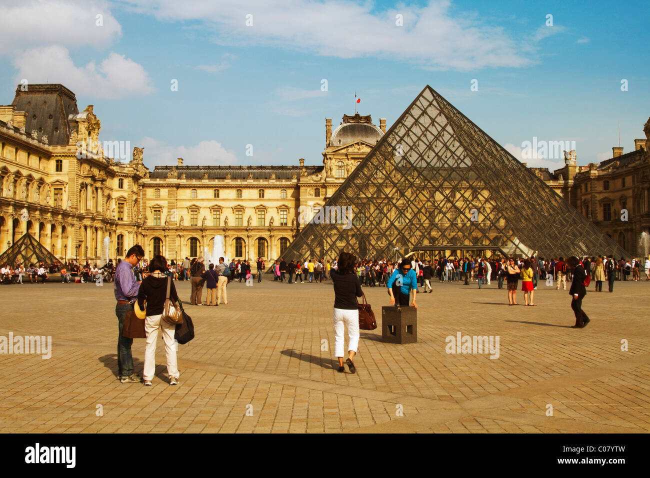 Tourists near a pyramid, Louvre Pyramid, Musee du Louvre, Paris, France Stock Photo