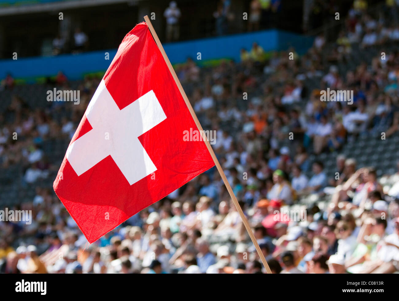 Swiss fan waving the national flag at a sports event Stock Photo