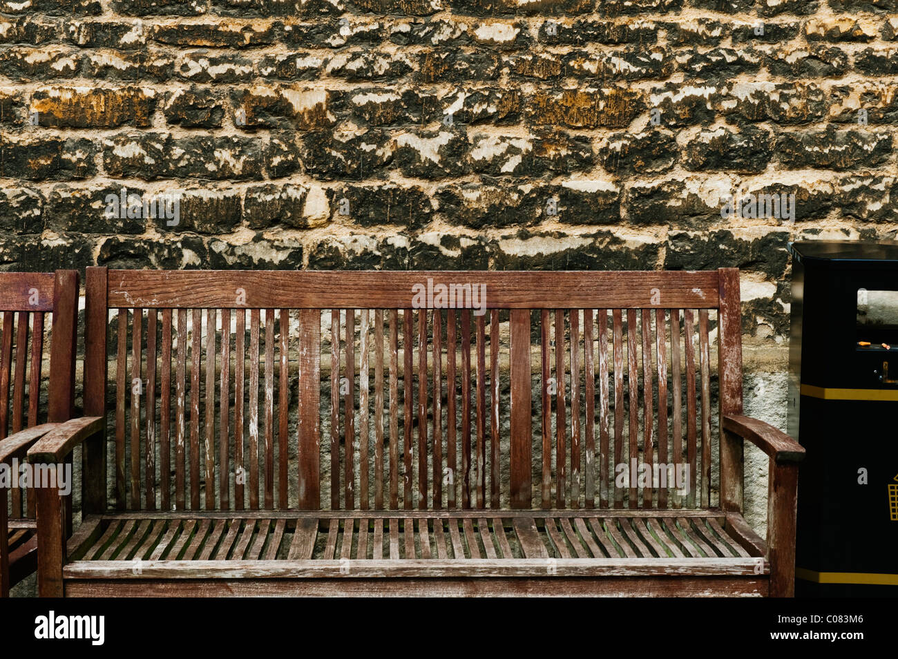 Benches in front of a weathered wall, Oxford, Oxfordshire, England