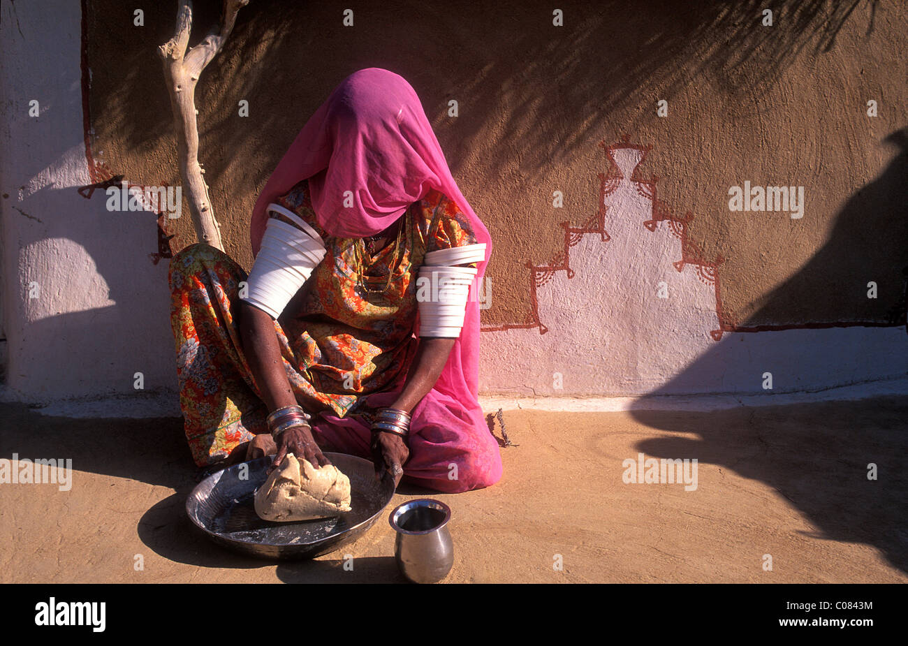 Young Indian woman in sari kneads dough for chapati bread, Thar Desert, Rajasthan, India, Asia Stock Photo