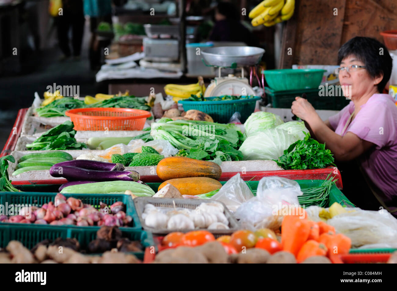 woman selling vegetables food wet market jalan petaling street kuala lumpur chinatown malaysia malaysian chinese food Stock Photo