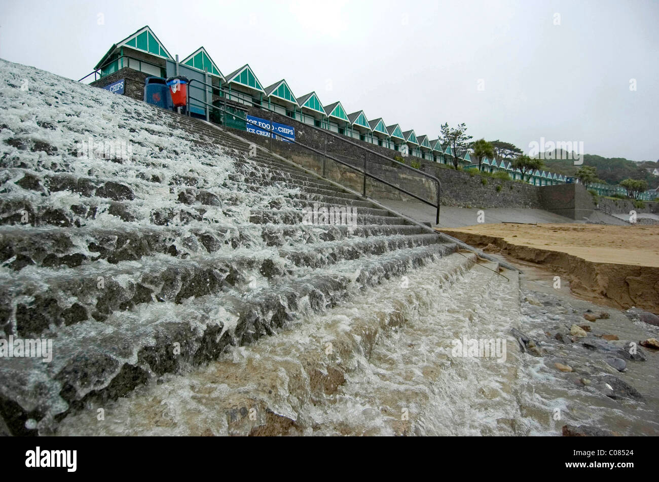 Heavy rain running down the steps at Langland Bay near Swansea in the middle of the British summertime. Stock Photo