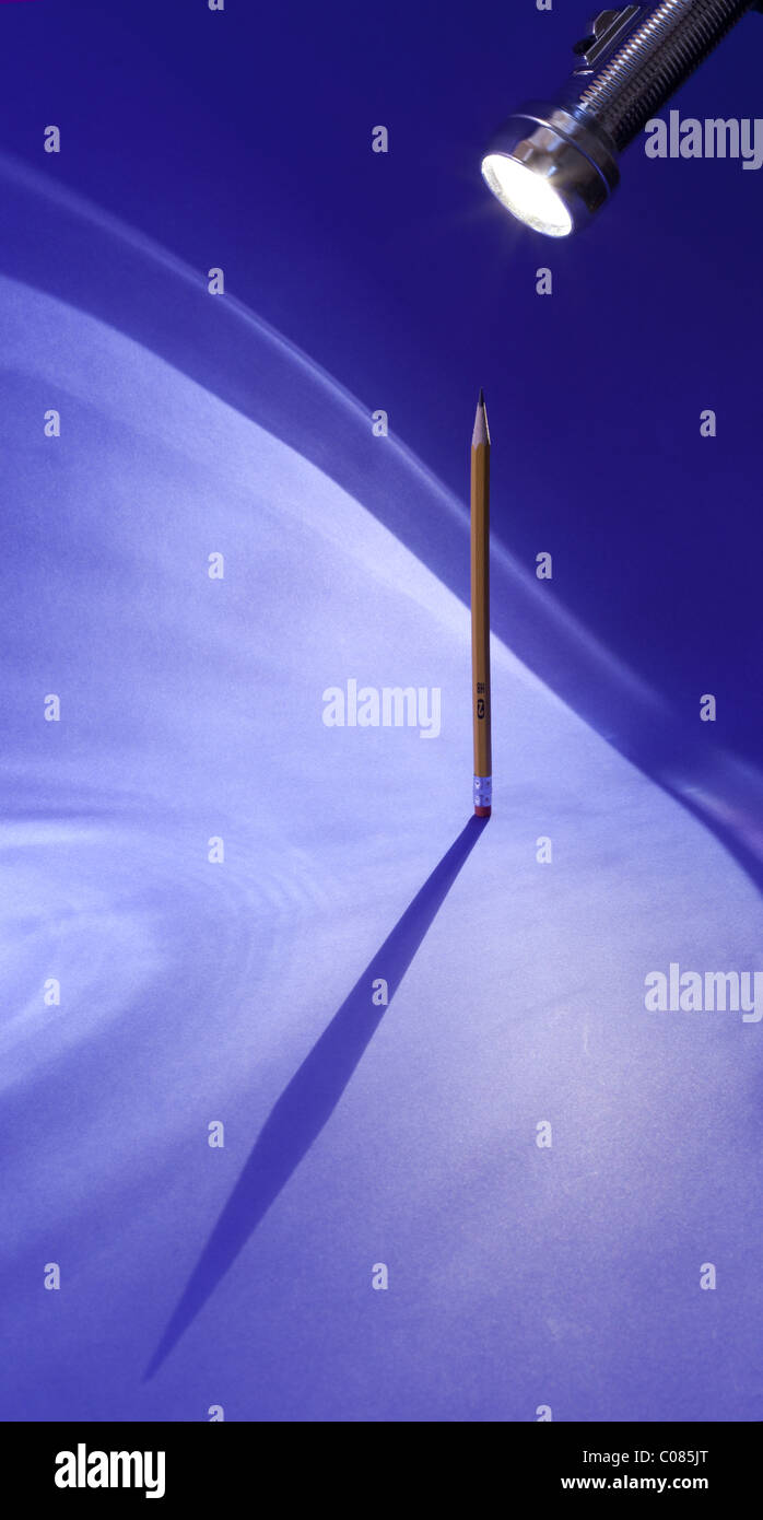 Shadow of a #2 pencil on a blue background Stock Photo