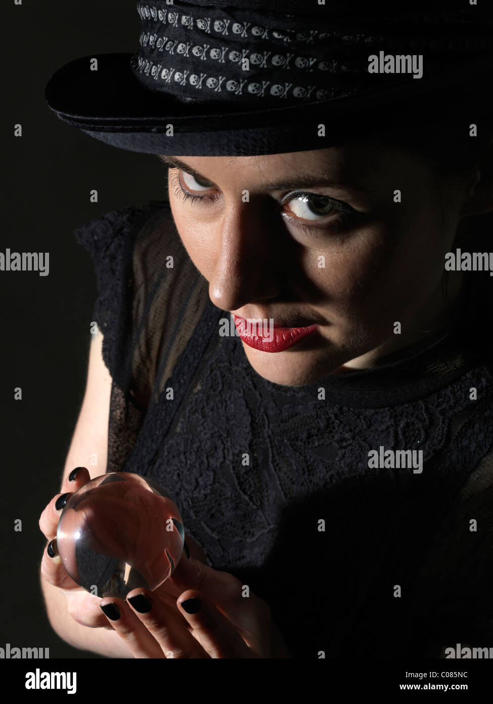 Woman holding up crystal ball hi-res stock photography and images - Alamy