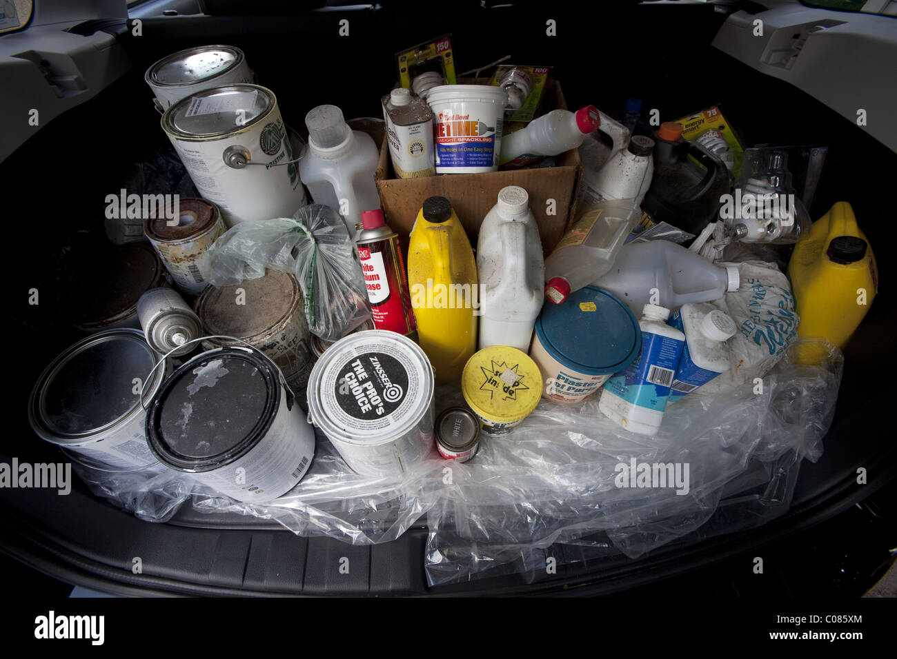 Containers of toxic and hazardous household chemicals being taken to designated recyclers Stock Photo