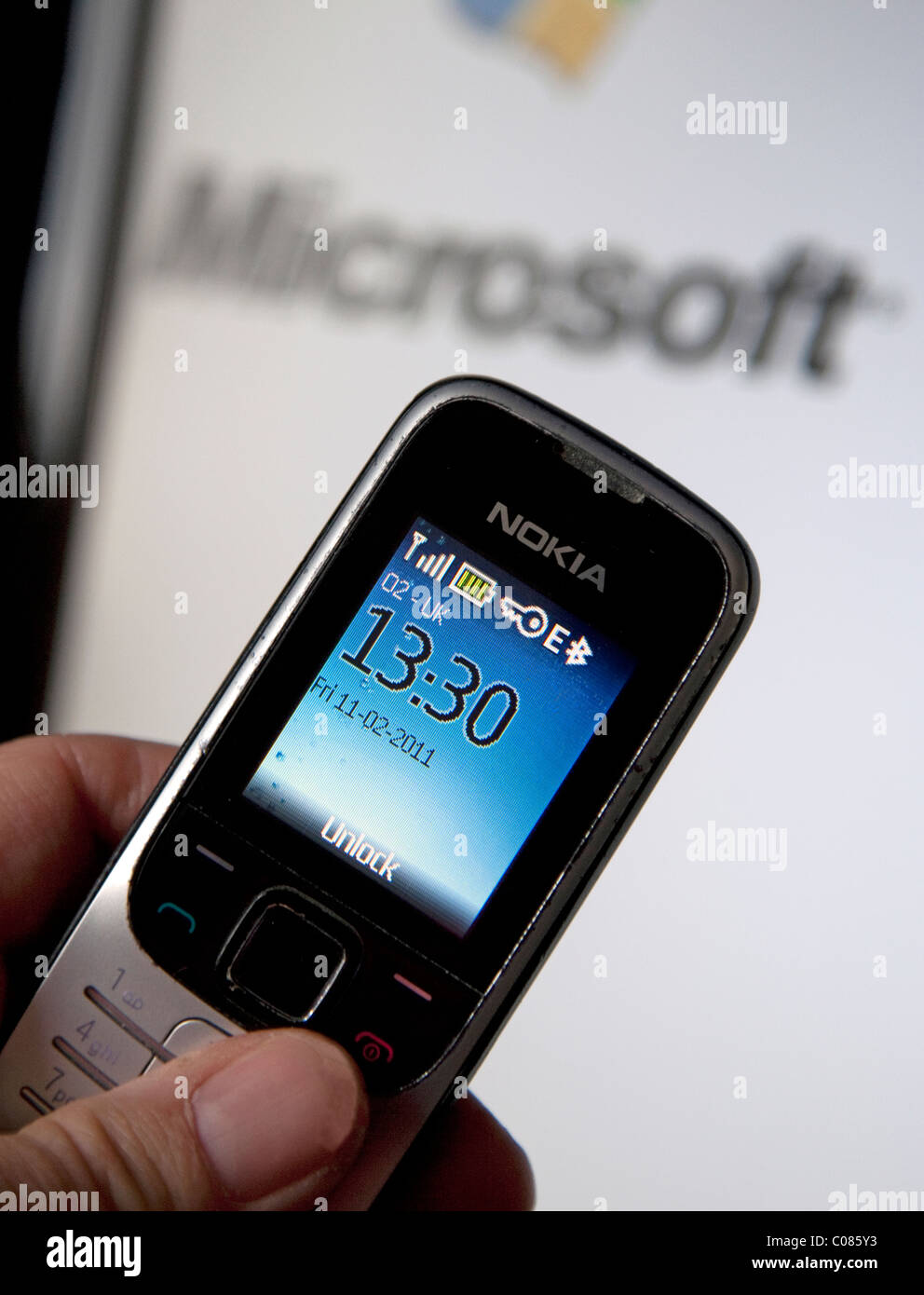 Nokia mobile phone and Microsoft logo on computer screen Stock Photo