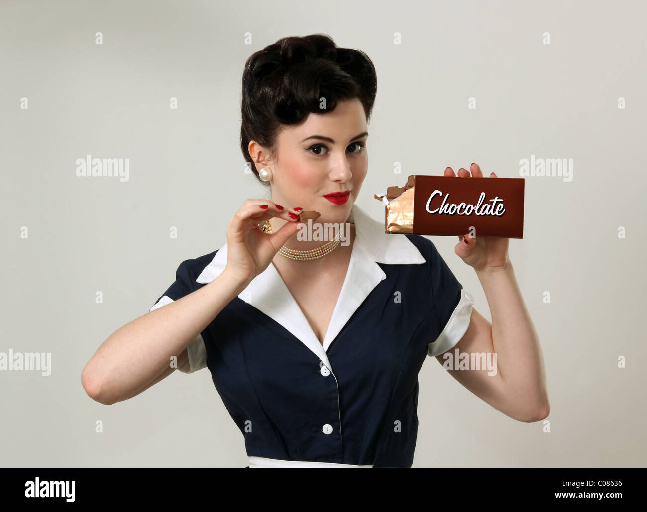Woman eating a bar of chocolate Stock Photo