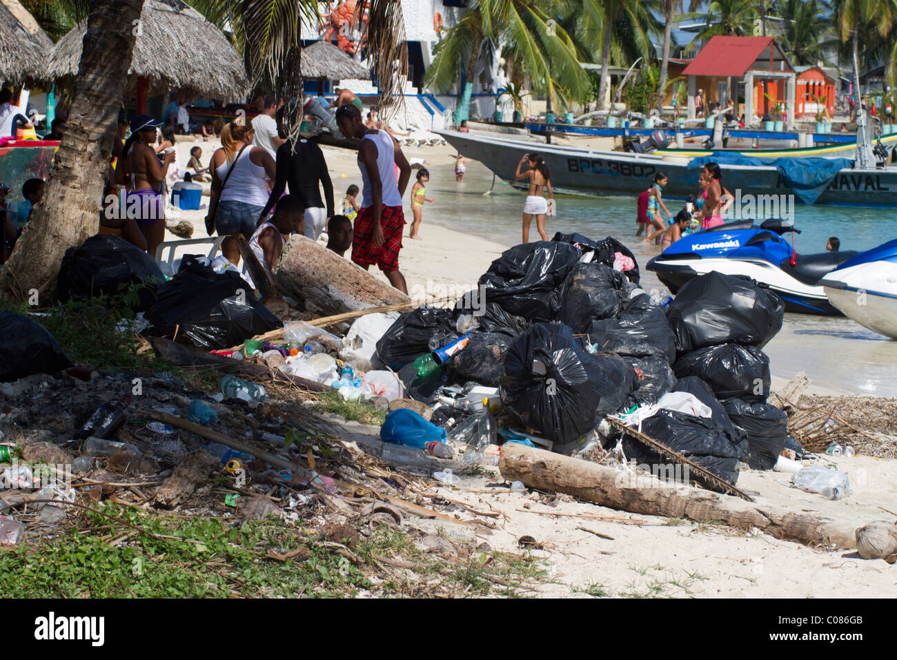 A pile of garbage bags on Isla Grande's beaches near the tourists. Colon, Republic of Panama, Central America Stock Photo