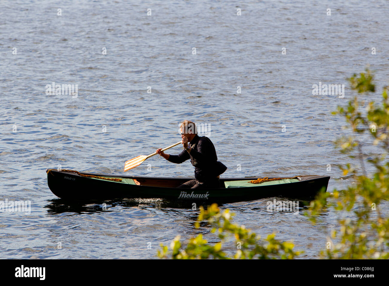 loan single canoeist on Lake Windermere Stock Photo