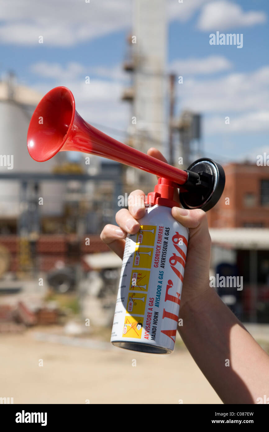 Hand held / hand holding an aerosol / compressed air / gas horn / foghorn  Stock Photo - Alamy